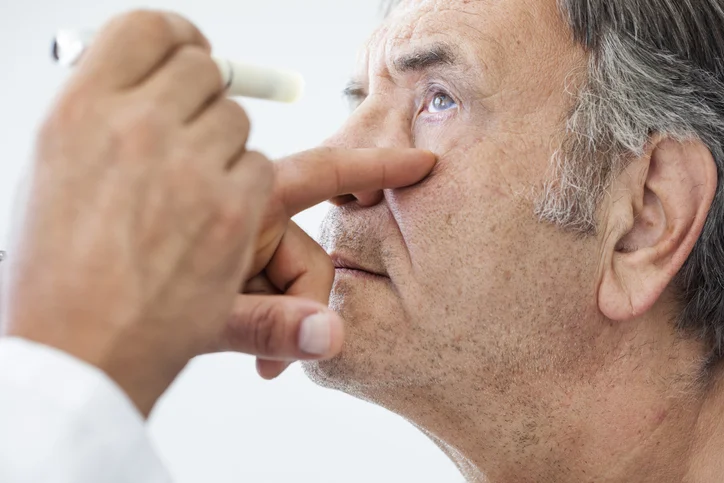 An eye doctor examining a patient's eye