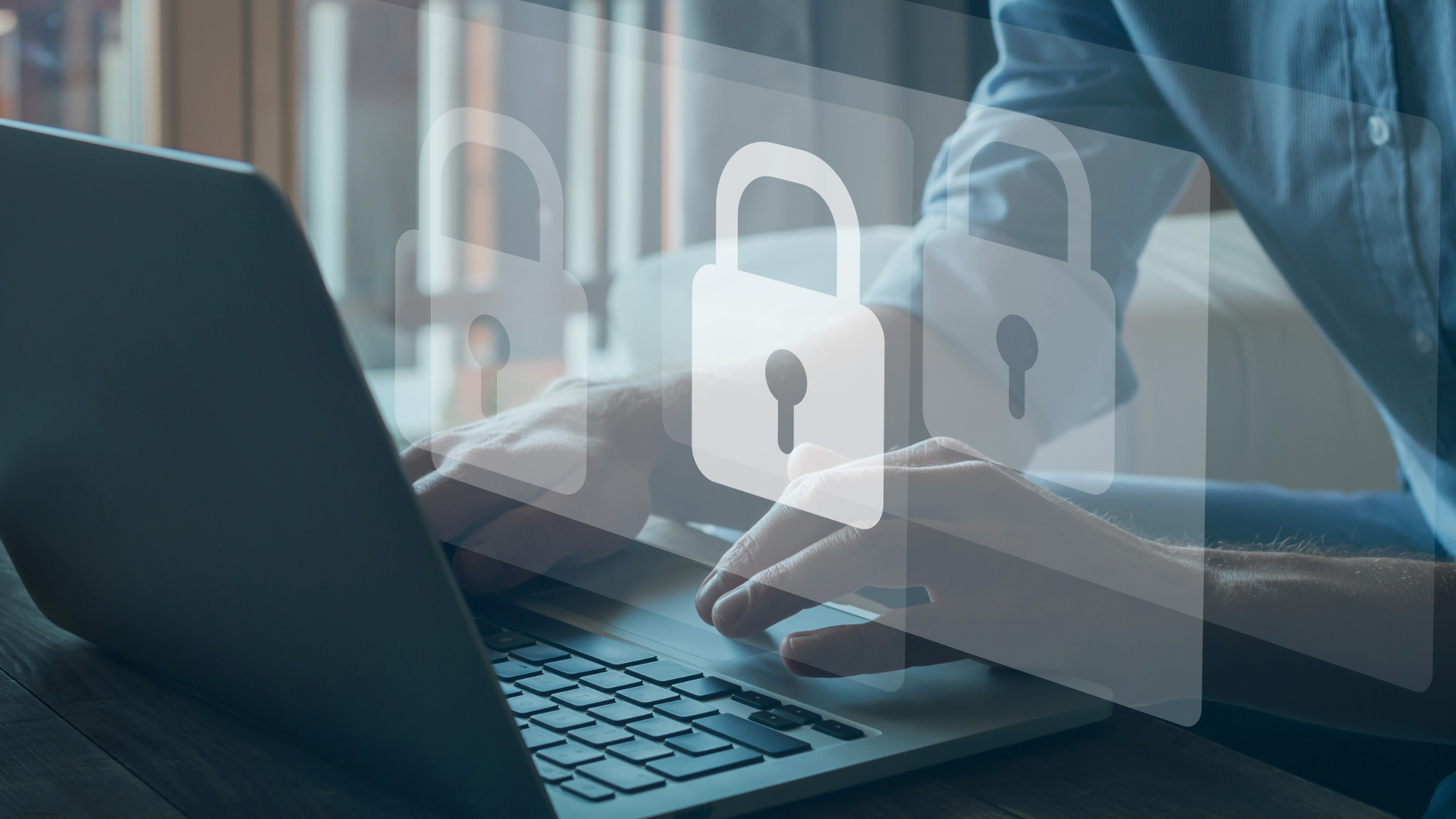 Hands typing on a laptop with floating padlock icons, symbolizing online security and data privacy.