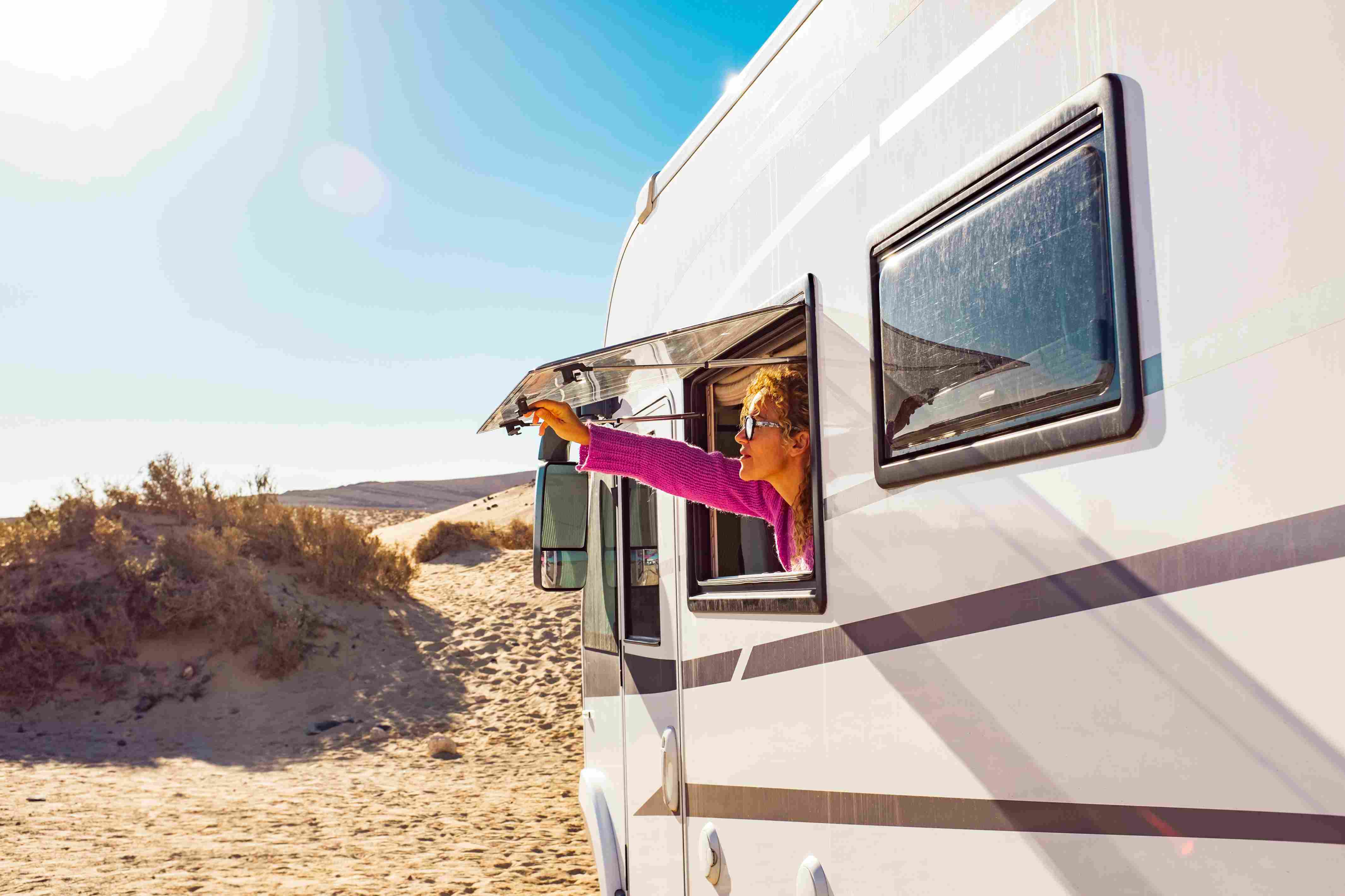 Woman opens mobile home window