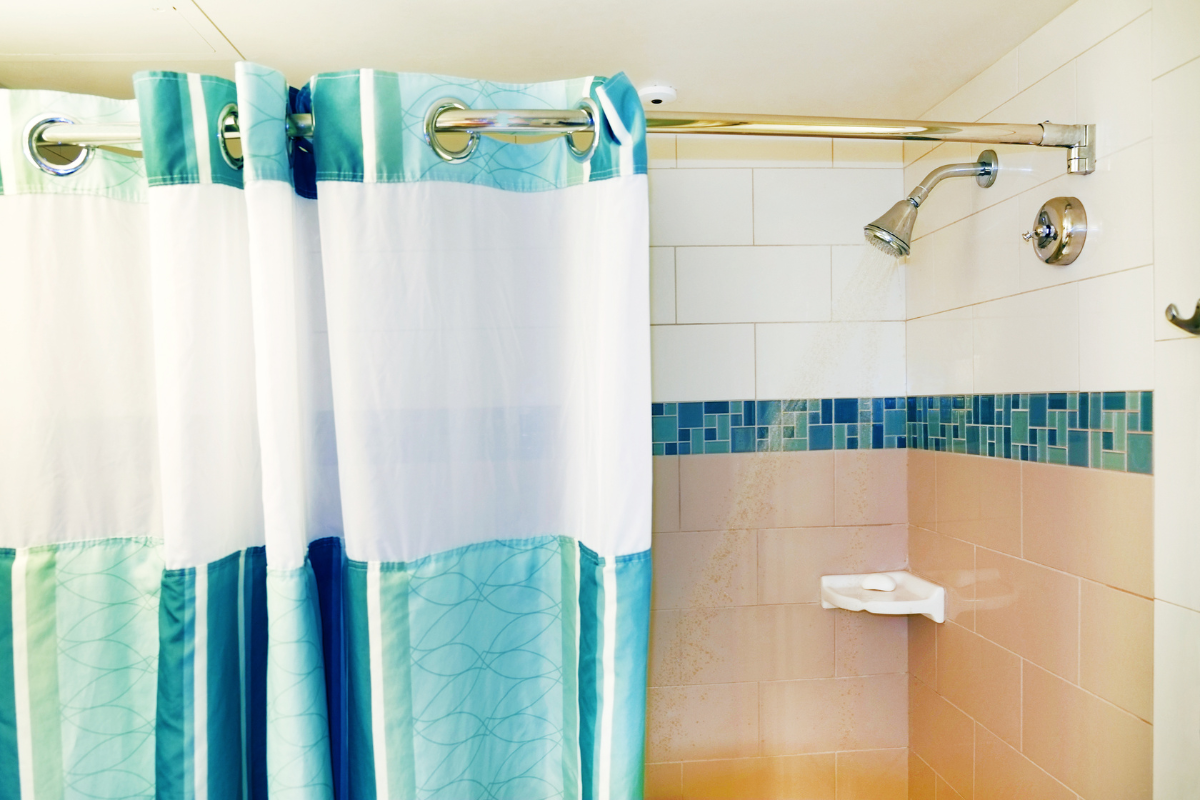 A creative depiction of budget-friendly shower curtain ideas in a small bathroom, complementing small bathroom remodel ideas.