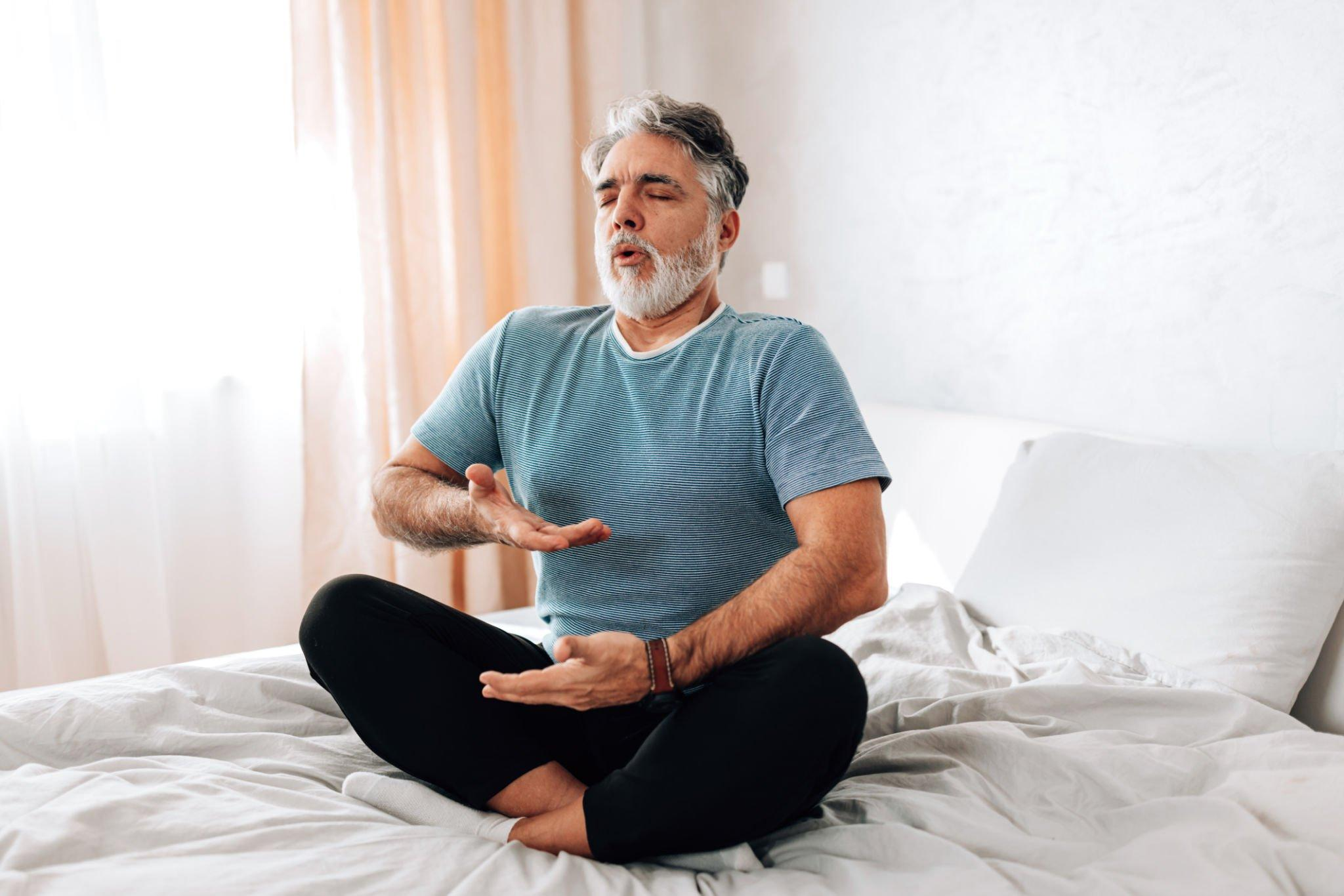 A person deeply engaged in a breathing exercise, demonstrating one of the effective stress management practices to relieve stress and mitigate the potential impacts of stress and diabetes.