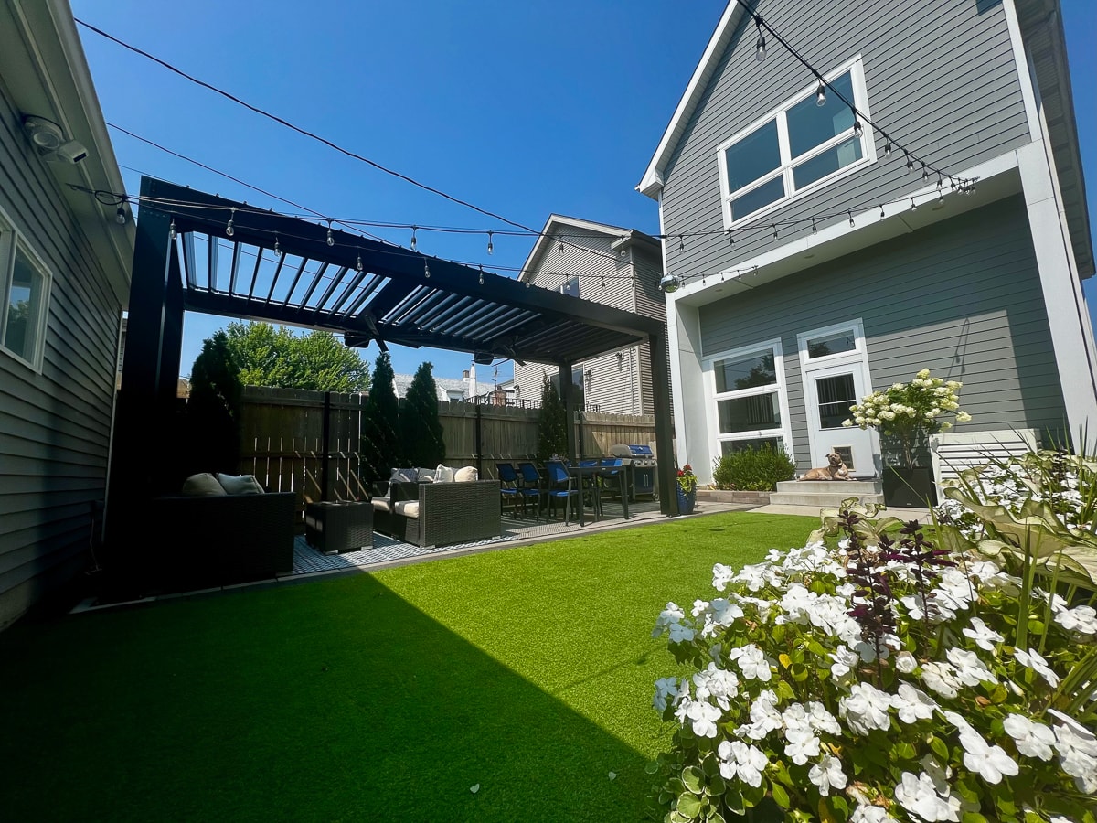 Freestanding Luxury Pergola installed over patio with outdoor seating.