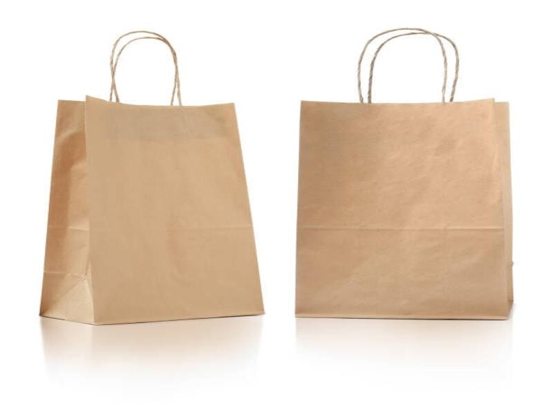 Durable kraft paper bags for holding various items, including groceries, gifts, and everyday essentials. Sturdy paper-made handles assist in carrying various items. These eco-friendly paper bags are reusable and recyclable. They are great for providing strength, style, and sustainability for daily use. 