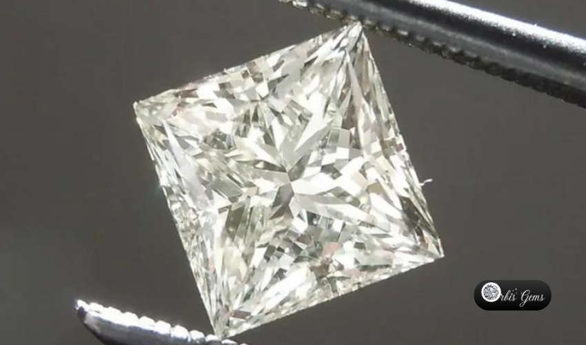 A stunning Princess Cut Diamond held by tweezers, displaying its intricate faceting and remarkable clarity, a testament to the timeless allure of Princess Cut Diamonds.