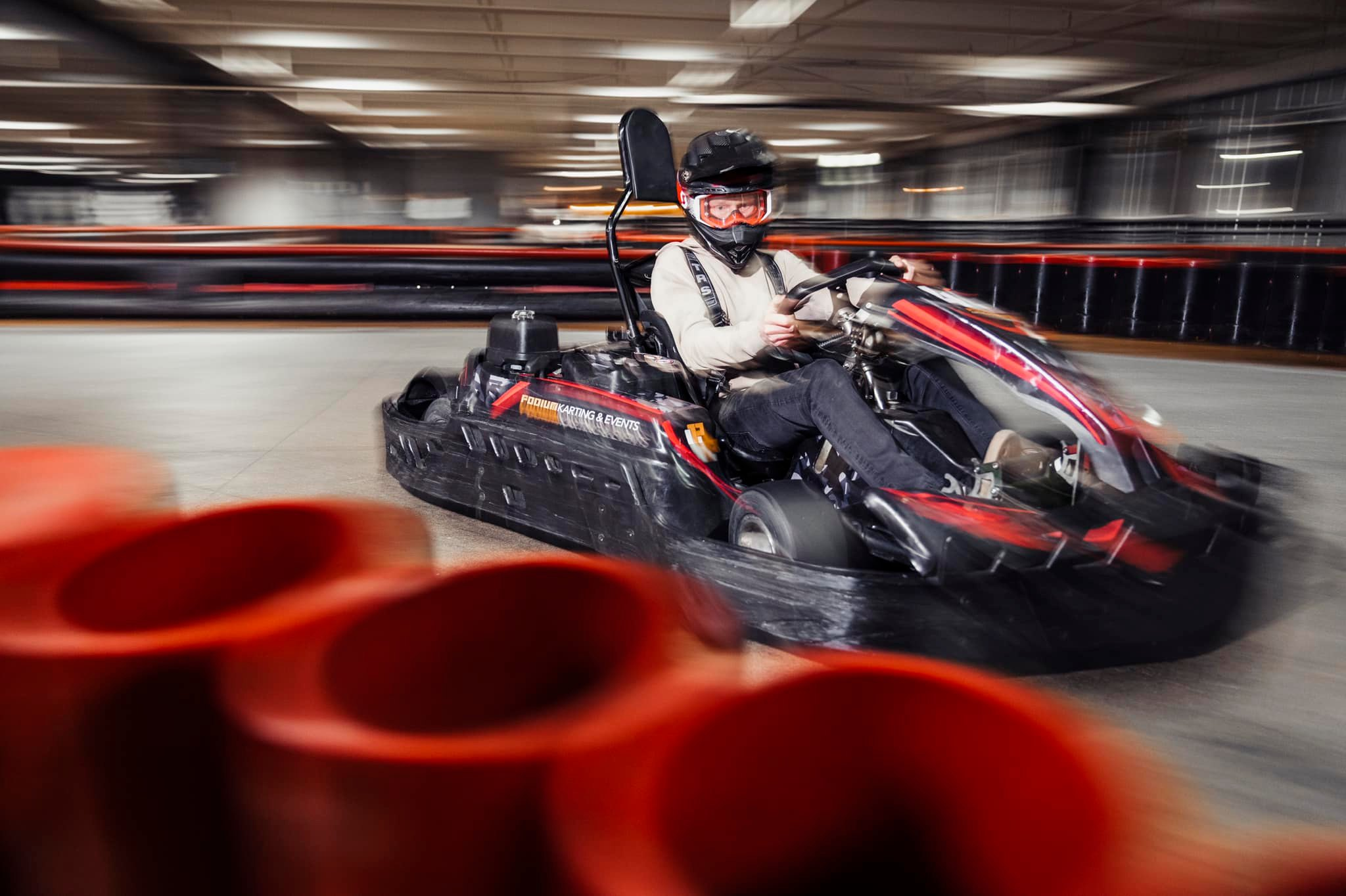 A man in a go-kart, racing at Podium Karting & Events