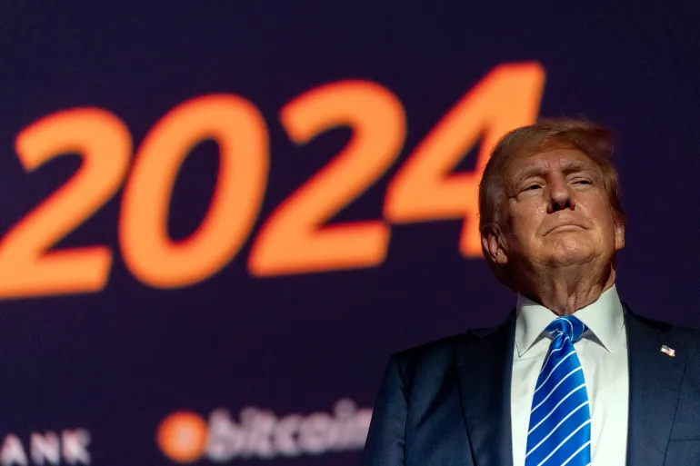 Bitcoin Conference - Market – president – businesses – bitcoin – blockchain – blockchain technology – cryptocurrencies – digital assets  An image of Donald Trump standing at the 2024 Bitcoin Conference.