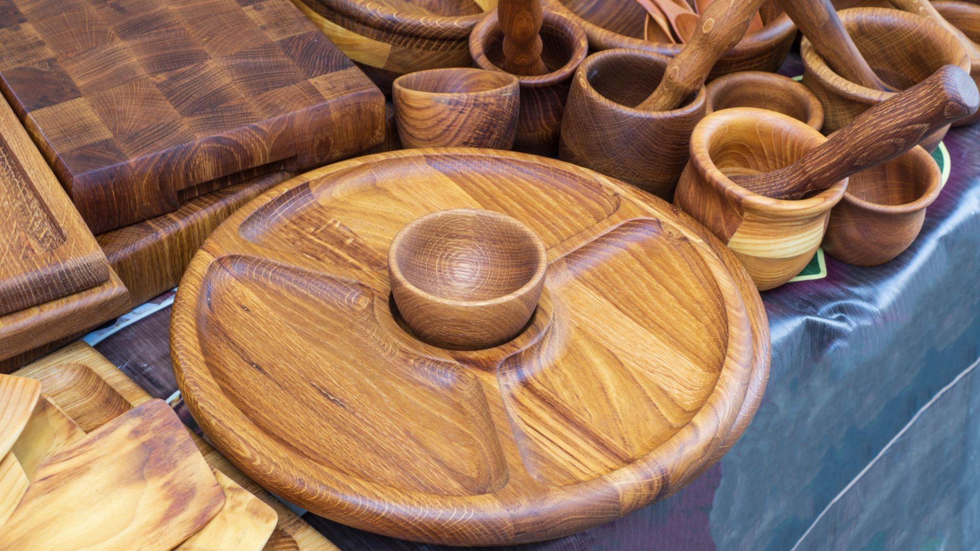 A series of wood turned bowls and other woodworking projects on a table.