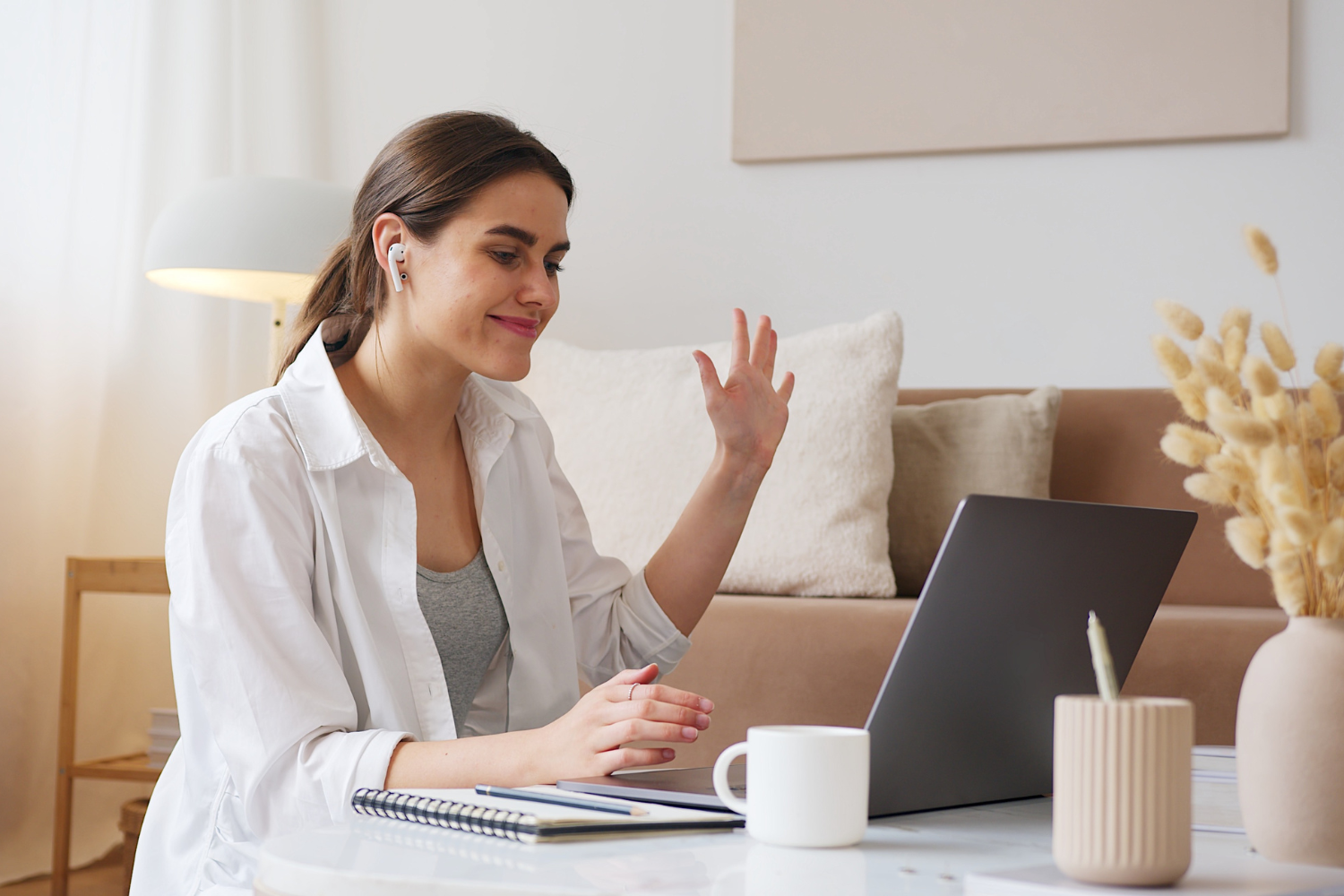 Interviewer saying hi on video call.