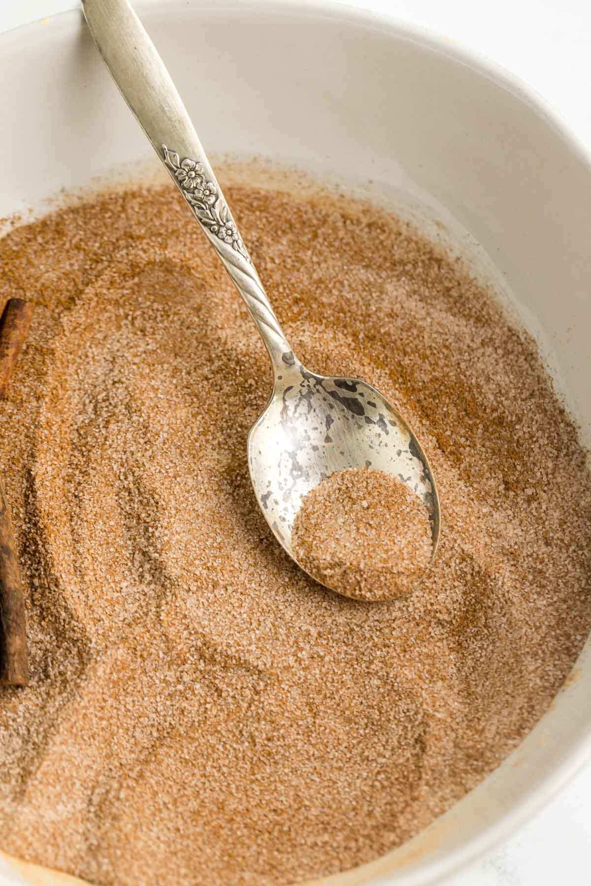 bowl of cinnamon sugar with a spoon in it