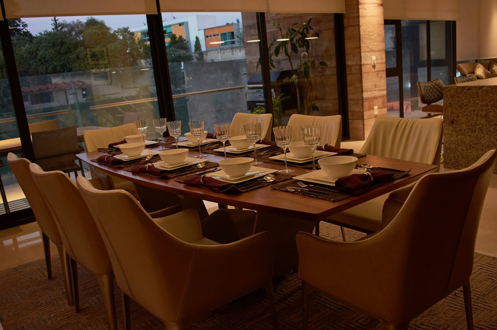 A beautifully arranged dining room table with fine place settings and stylish chairs, ideal for a fine dining atmosphere.
