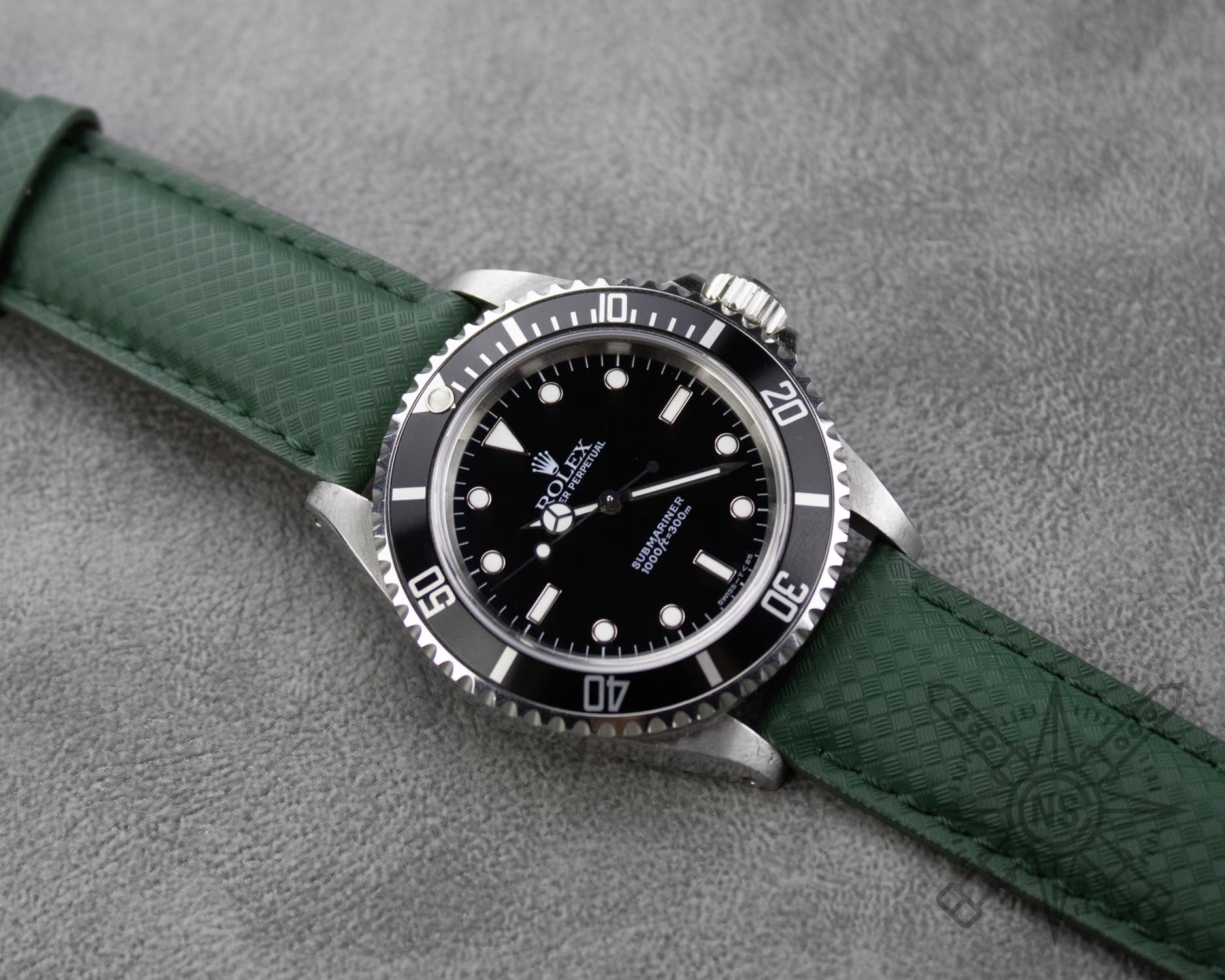 Rolex Submariner on a green rubber watch strap