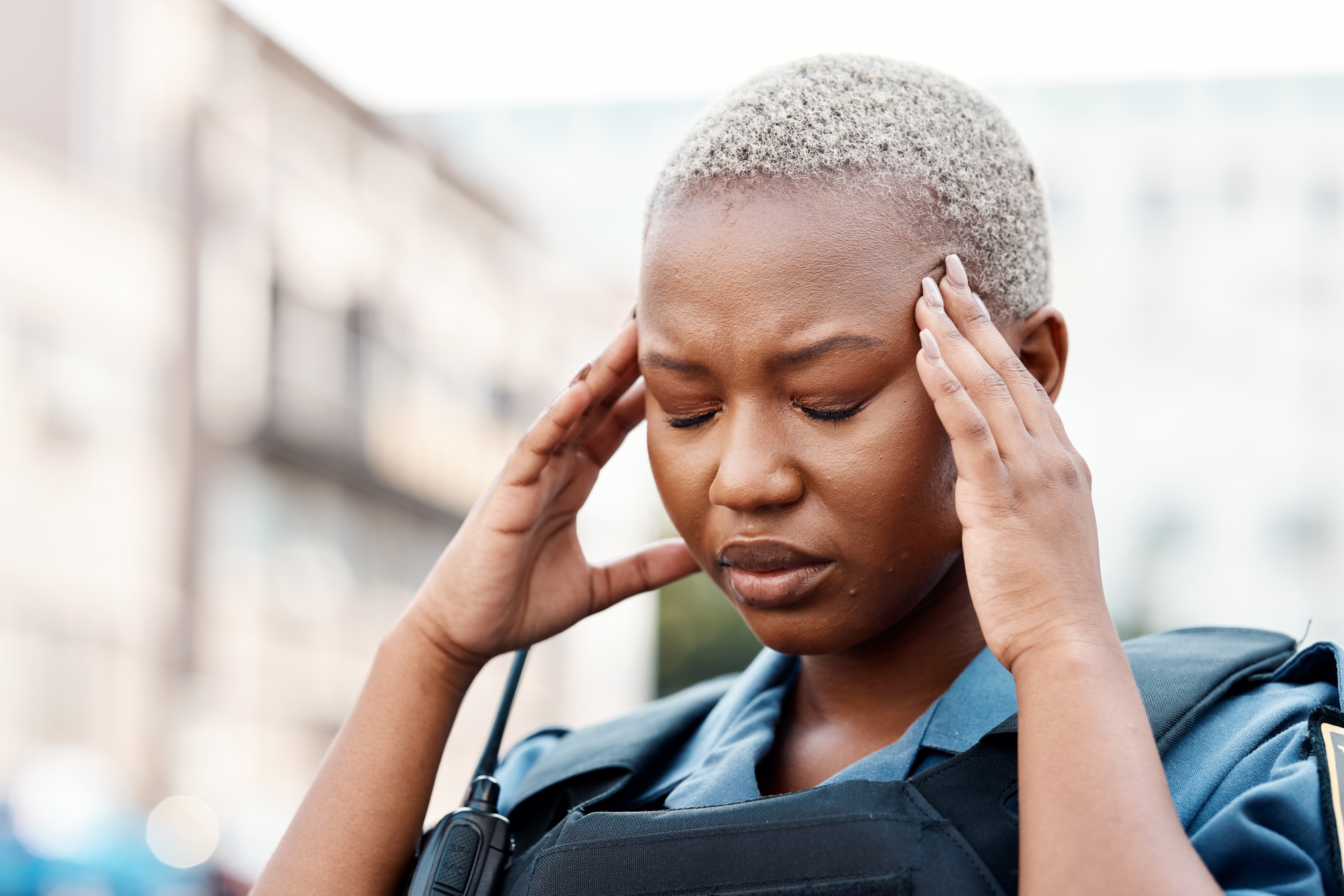 Woman with a headache wondering "can wisdom teeth cause a headache?"