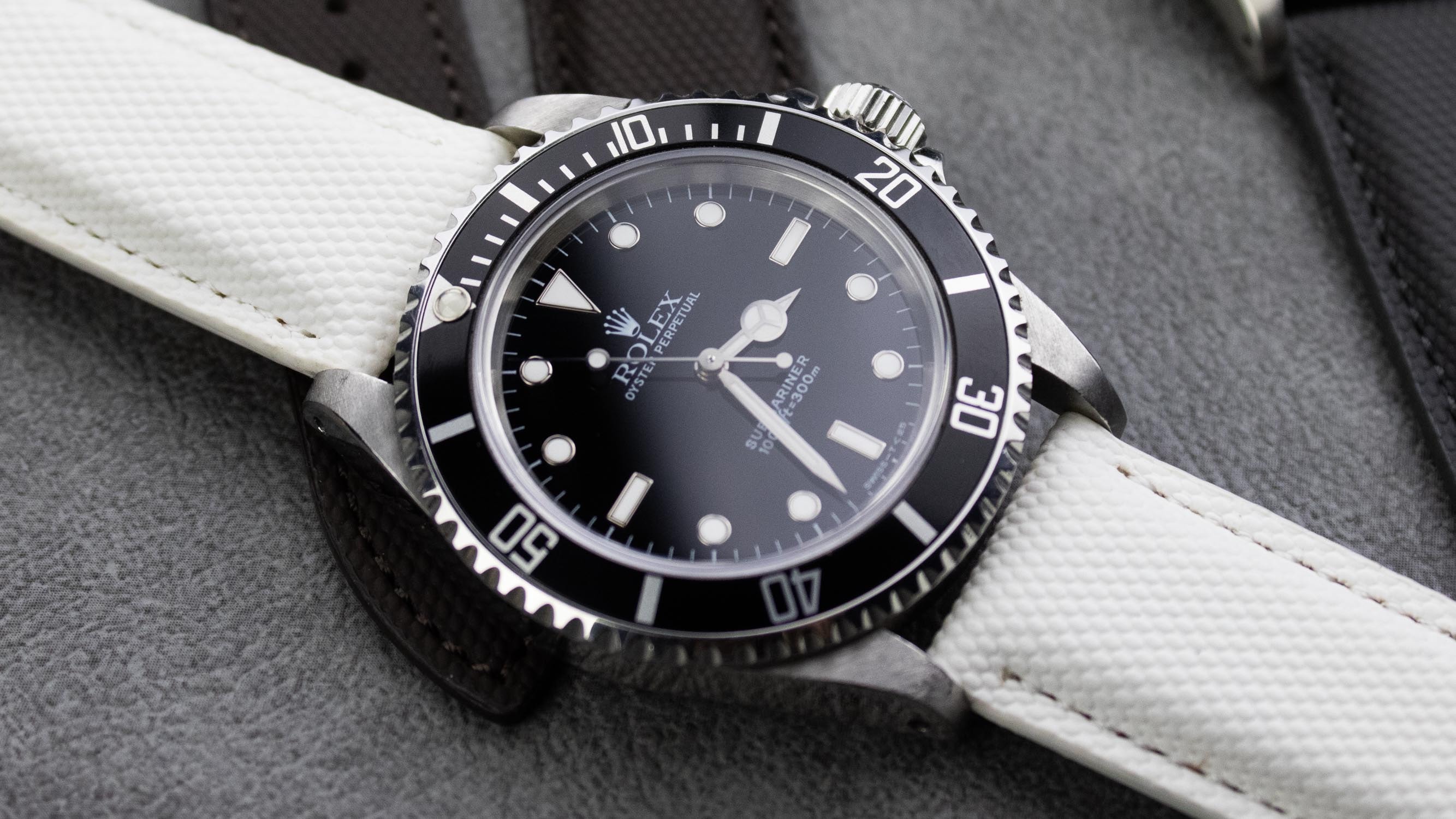 A close-up of a white sailcloth watch strap on a wrist, showcasing its appeal.