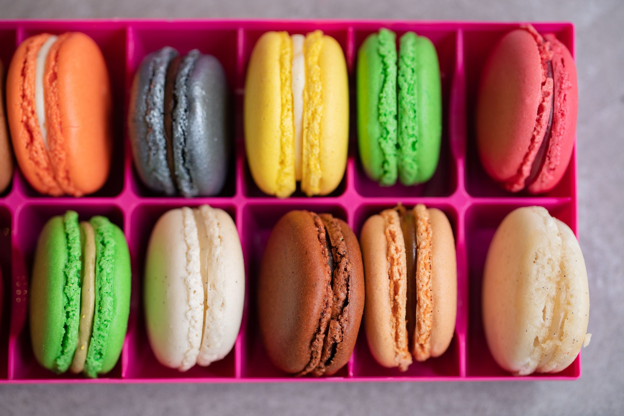 Commercial photo of a box of colourful macarons