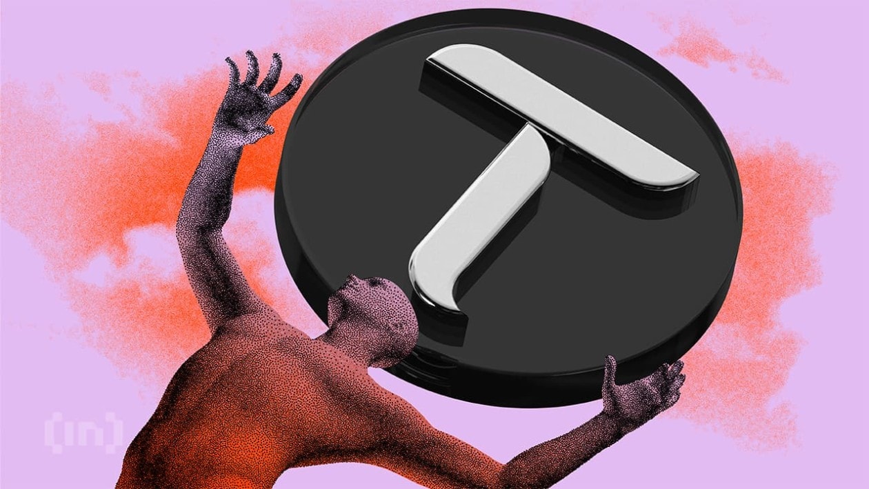 A surreal digital artwork featuring a large 3D Bittensor logo (stylized "T" symbol) in black and metallic silver, held aloft by a textured humanoid figure with raised arms. The scene is set against a dreamy pink, purple, and orange gradient background with cloudy atmospheric effects, creating an ethereal, almost cosmic aesthetic that suggests themes of decentralized AI and human-technology interaction.