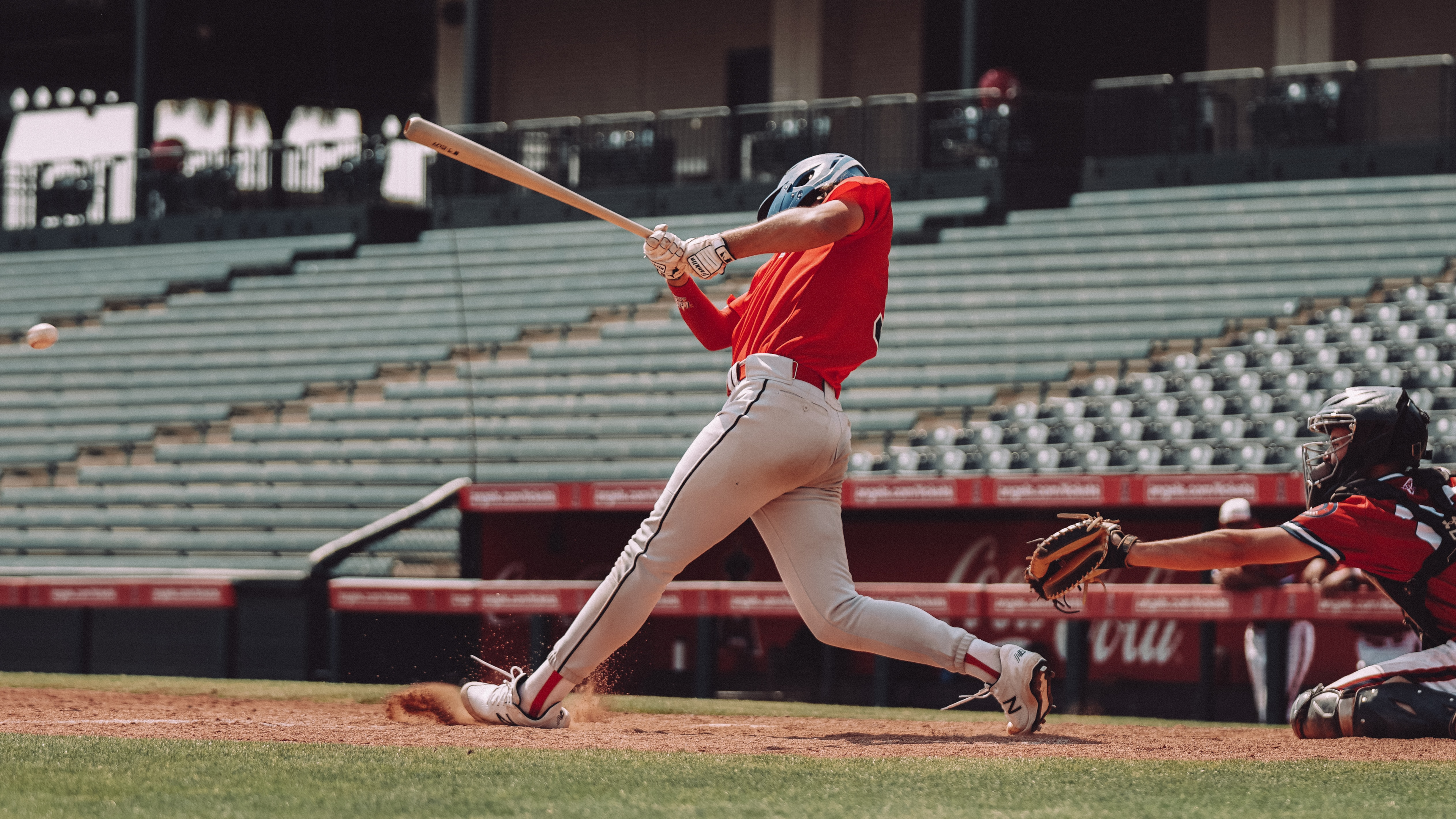 A baseball player swinging a corked bat