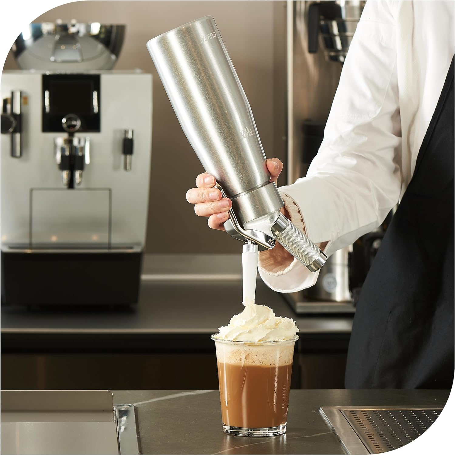 Whipped Cream being made with a whipper, sometimes called a cracker.