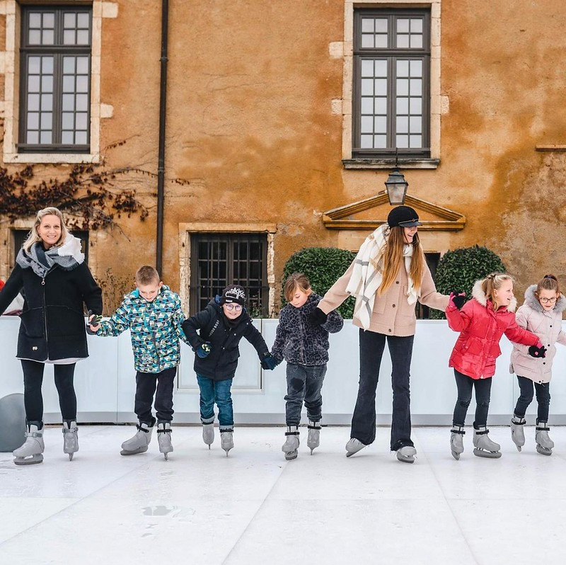 kids ice skating hand in hand