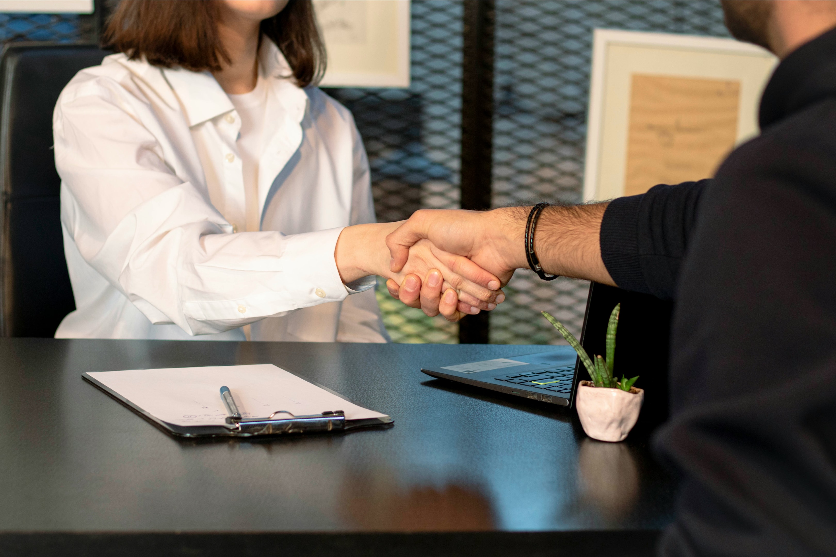 Handshake between real estate investor and private lender after successful deal made.
