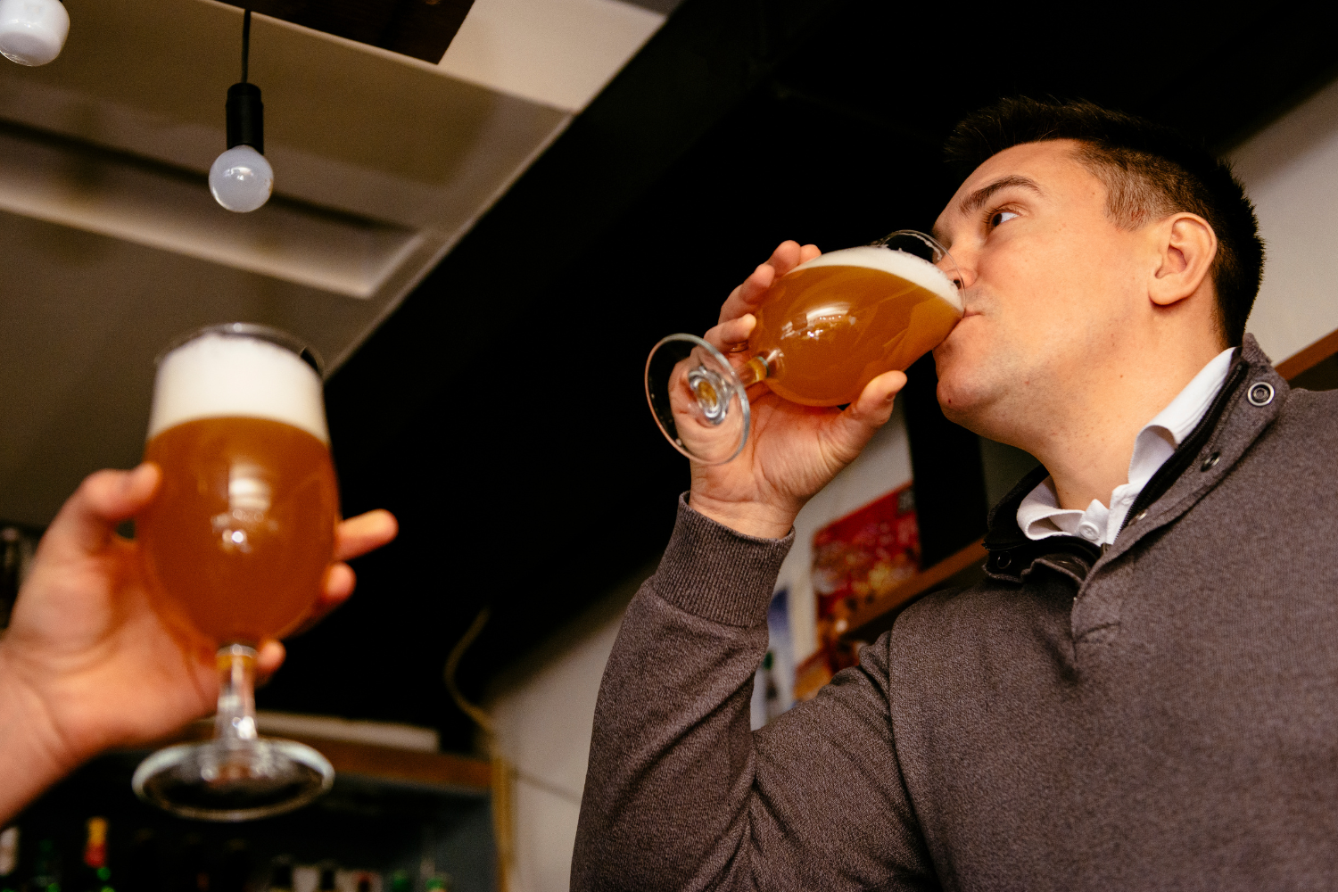 Two men drinking beer.