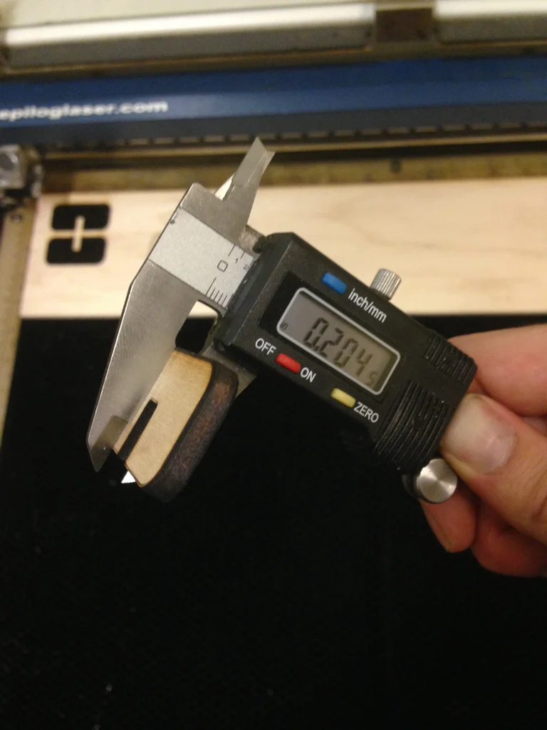 Measuring the actual kerf amount with calipers.