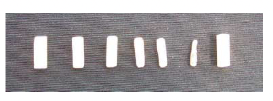 Pictured are a series of testosterone pellets including unimplanted pellets (extreme left and right) and a series of pellets extruded after various time intervals subdermally (33 days, 60 days, 78 days, 98 days and 143 days from left to right). Note preservation of cylindrical shape throughout the time in situ and the smooth clean white pellet surface.