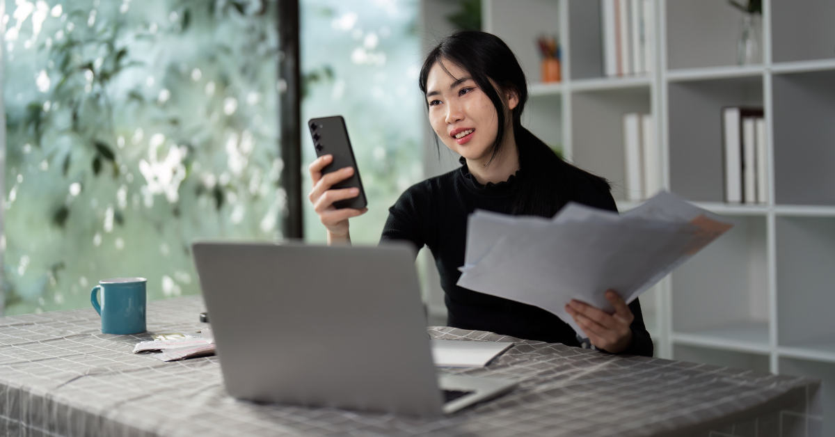 A woman tracking her business income and expenses with a spreadsheet