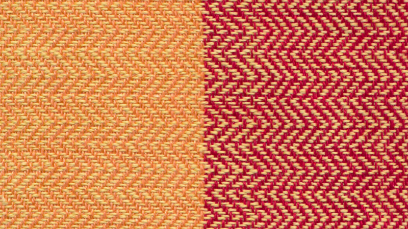 A red and yellow twill fabric with a chevron pattern