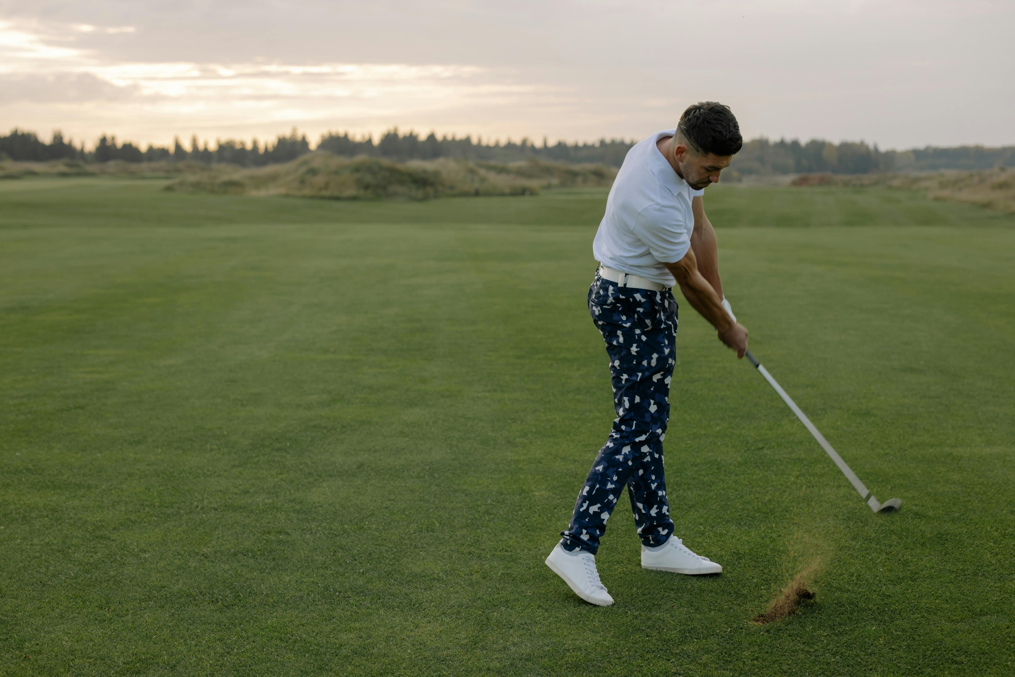 Photo by cottonbro studio: https://www.pexels.com/photo/man-in-white-polo-shirt-playing-golf-on-field-6256595/