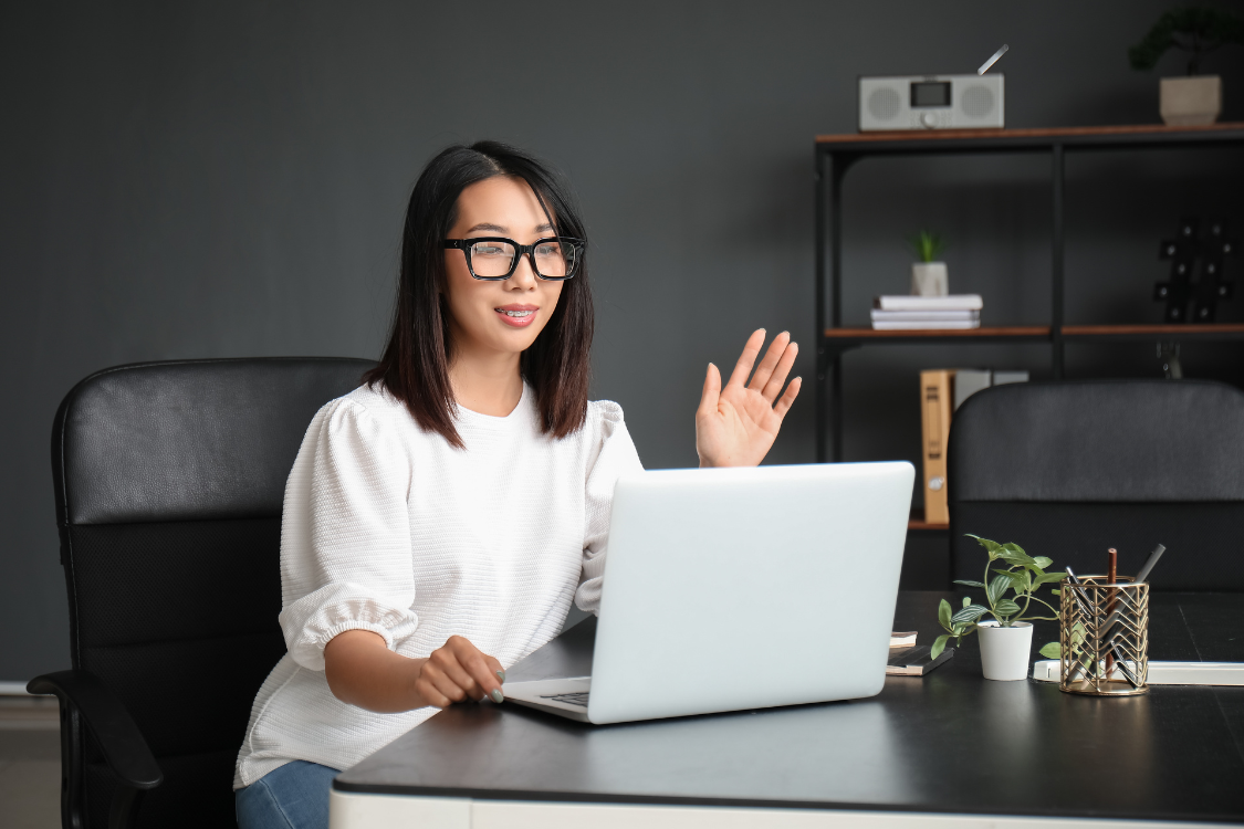 Filipino team member waving on a video call during a virtual onboarding or team check-in.