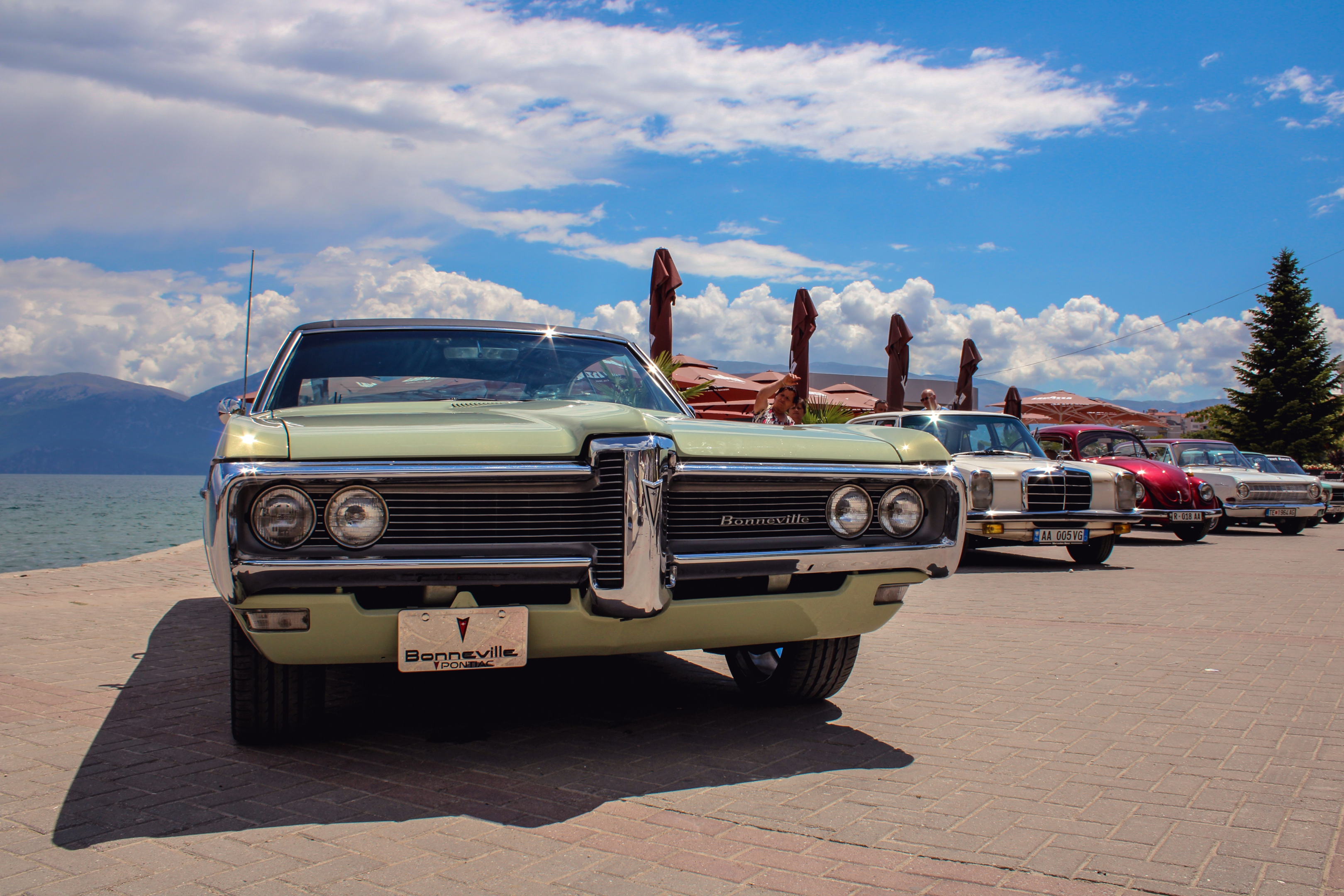 A row of random classic cars parked for a car show. We offer enclosed auto transport services.