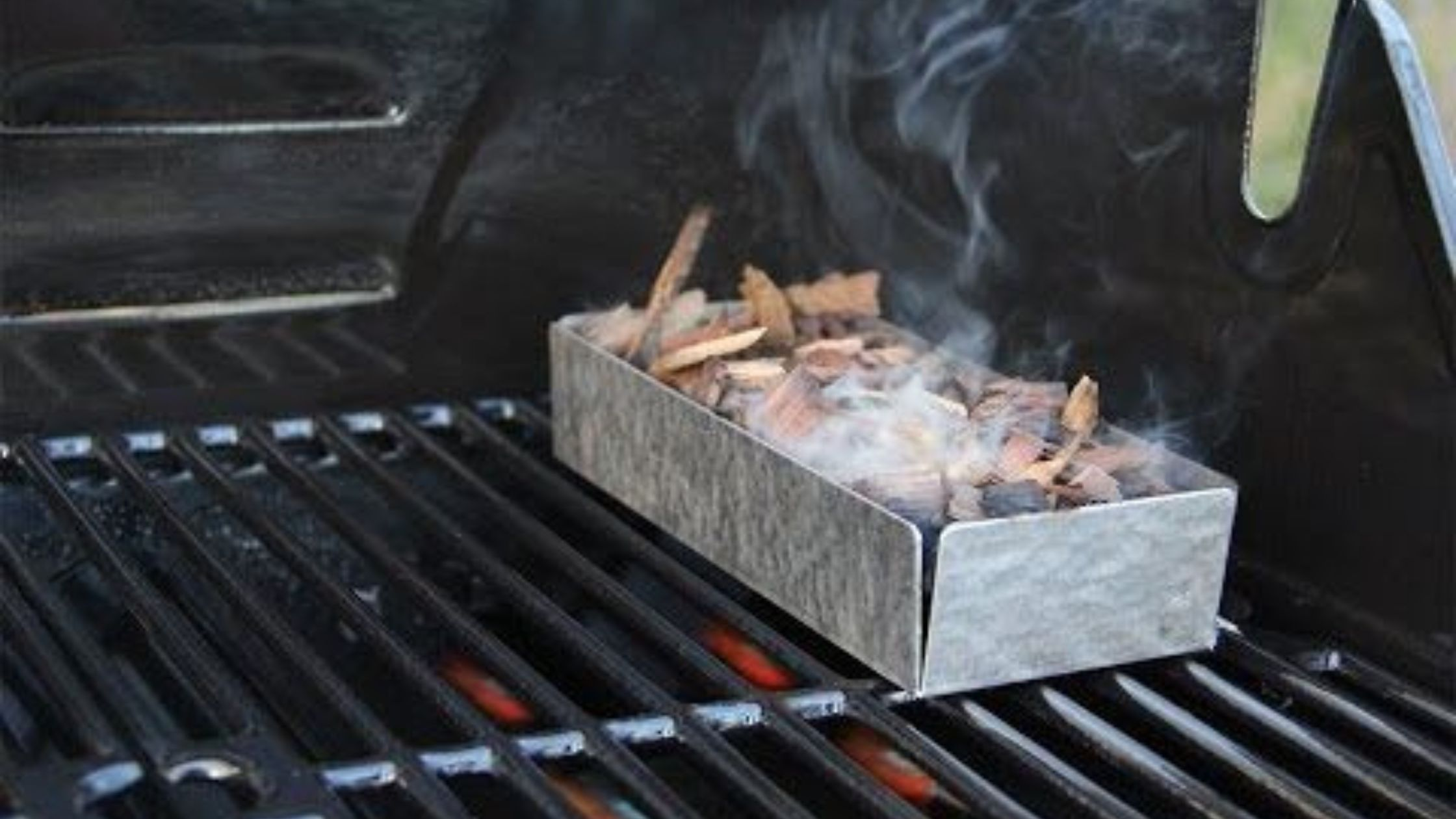 Wood Chips in Smoke Box on Hot Grill