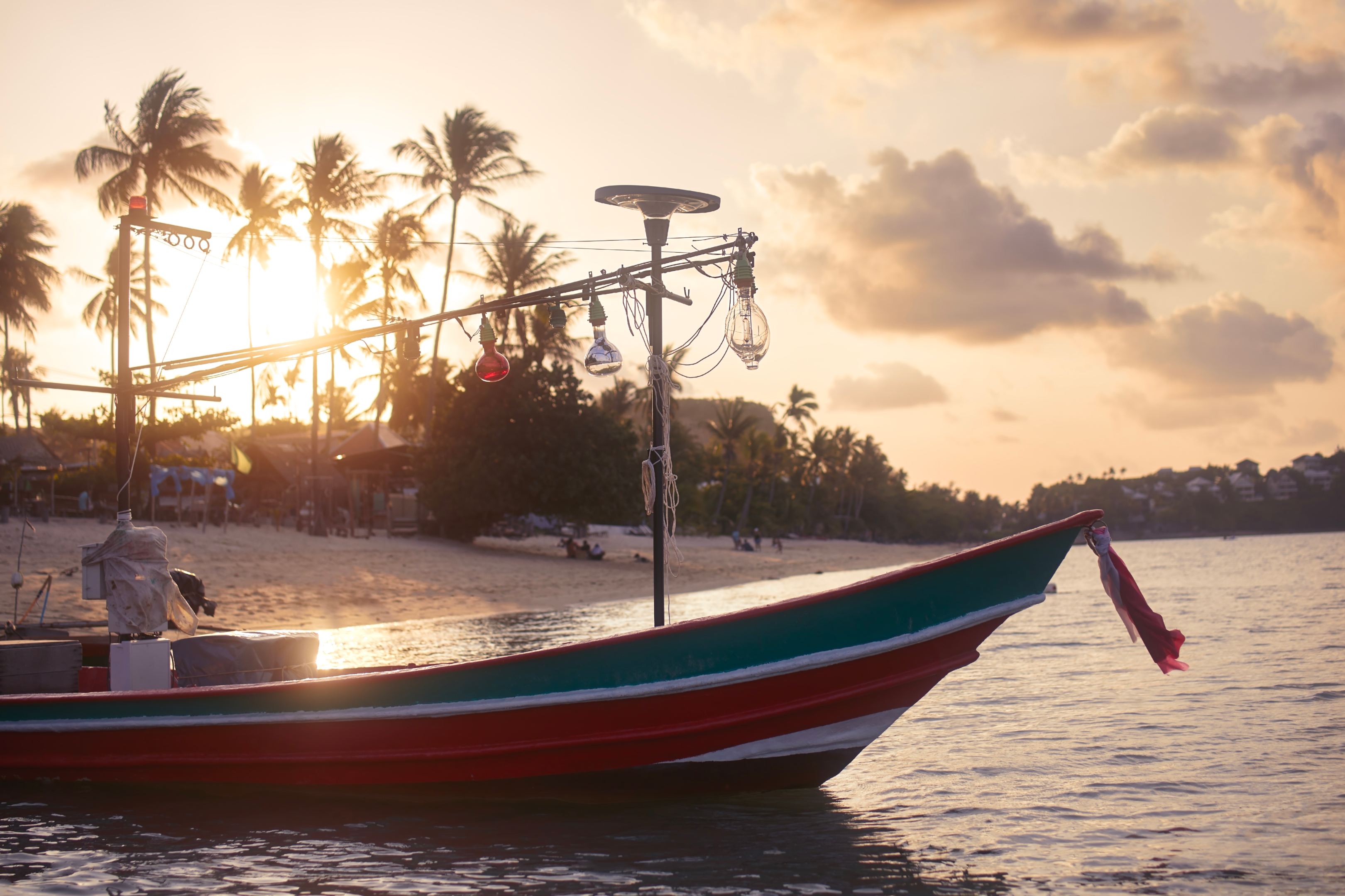 https://elements.envato.com/boat-near-idyllic-beach-with-palm-trees-at-sunset-YZG26B8