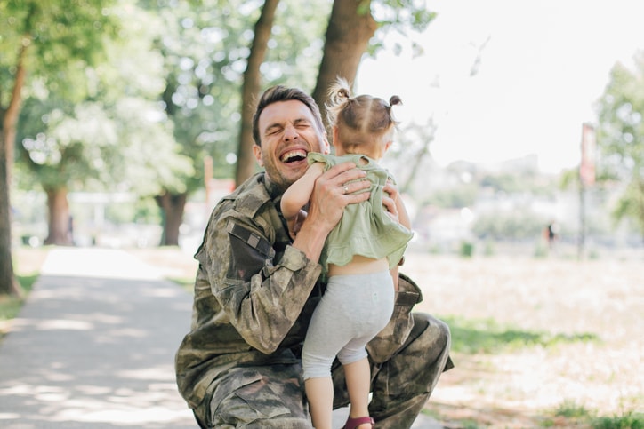 Veteran hugging his little girl.