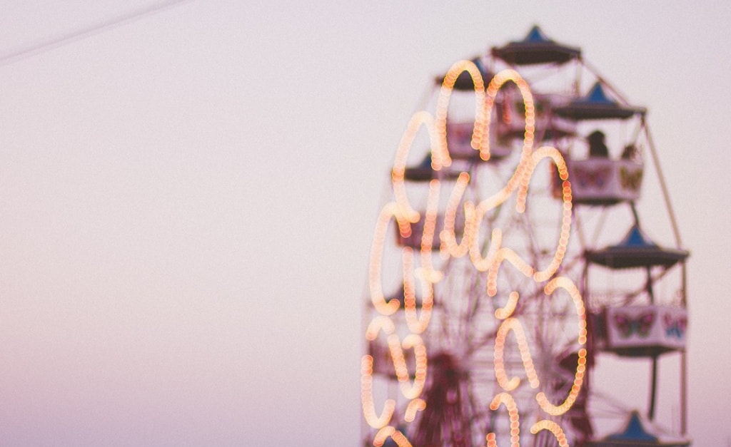 A softly focused image of a Ferris wheel