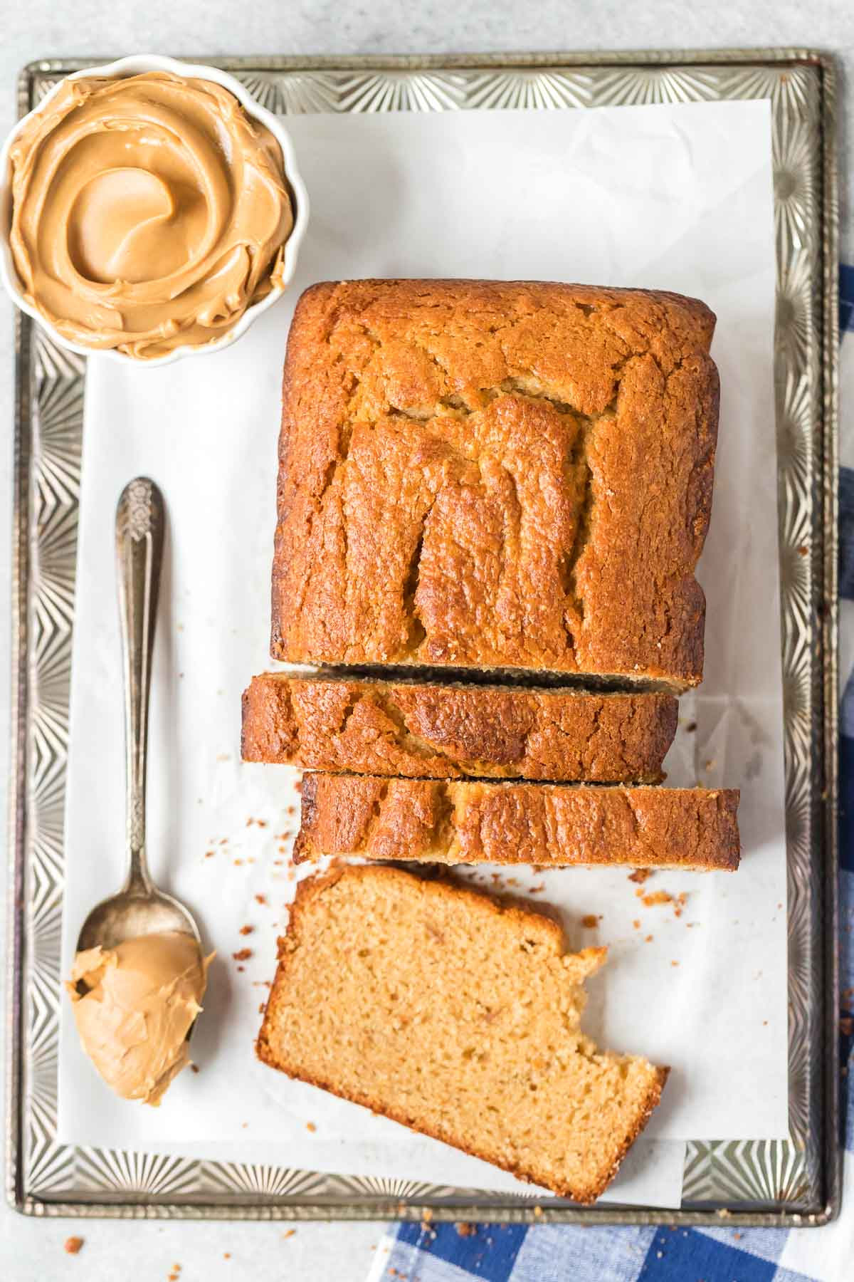 sliced peanut butter bread on a baking sheet with parchment paper