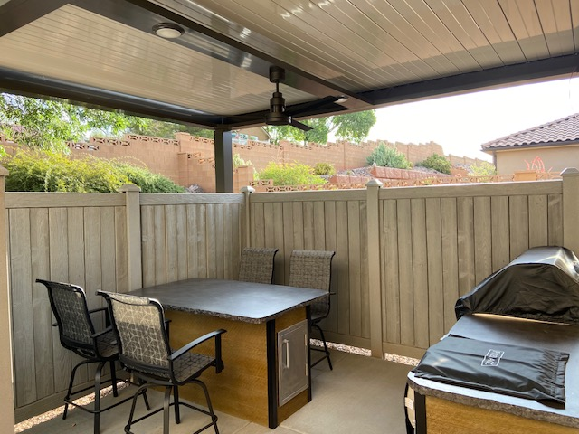 Cooking space with grill on patio outside of house with pergola stopping sun creating shade making great pergola ideas