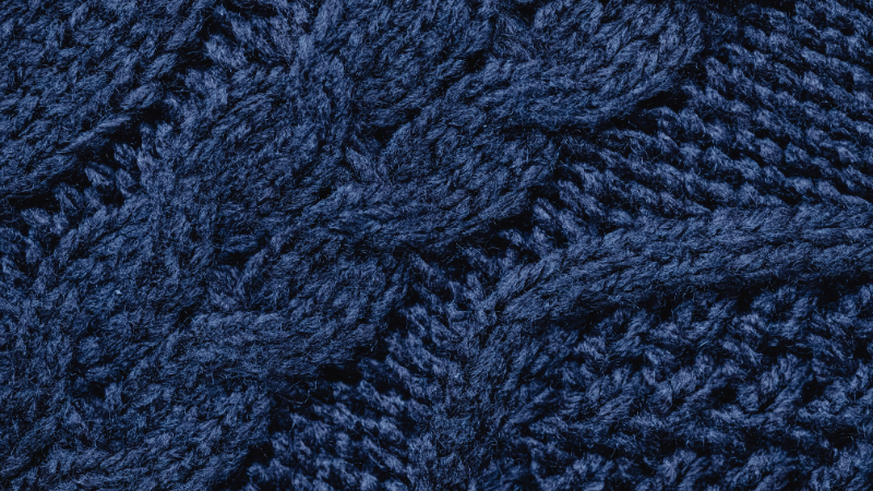 A close-up of a knitted sweater in dark blue
