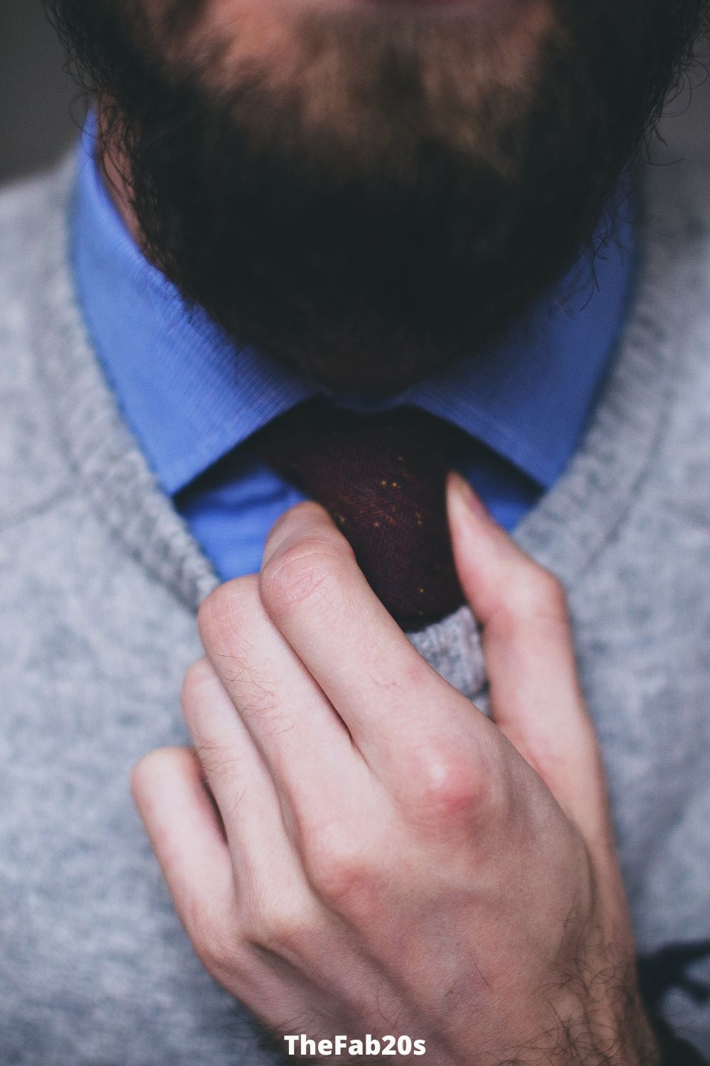 Man fixing his tie - Body language of a man secretly in love with you