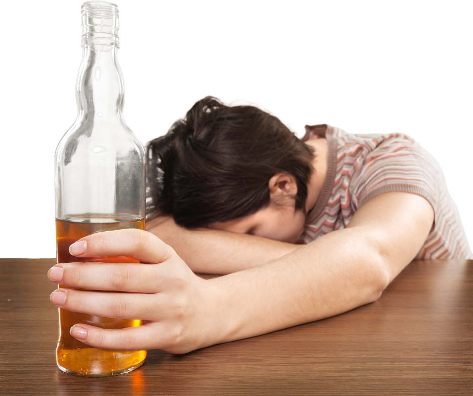 A person sitting alone with a glass of alcohol on the table, representing the question can an alcoholic stop drinking on their own