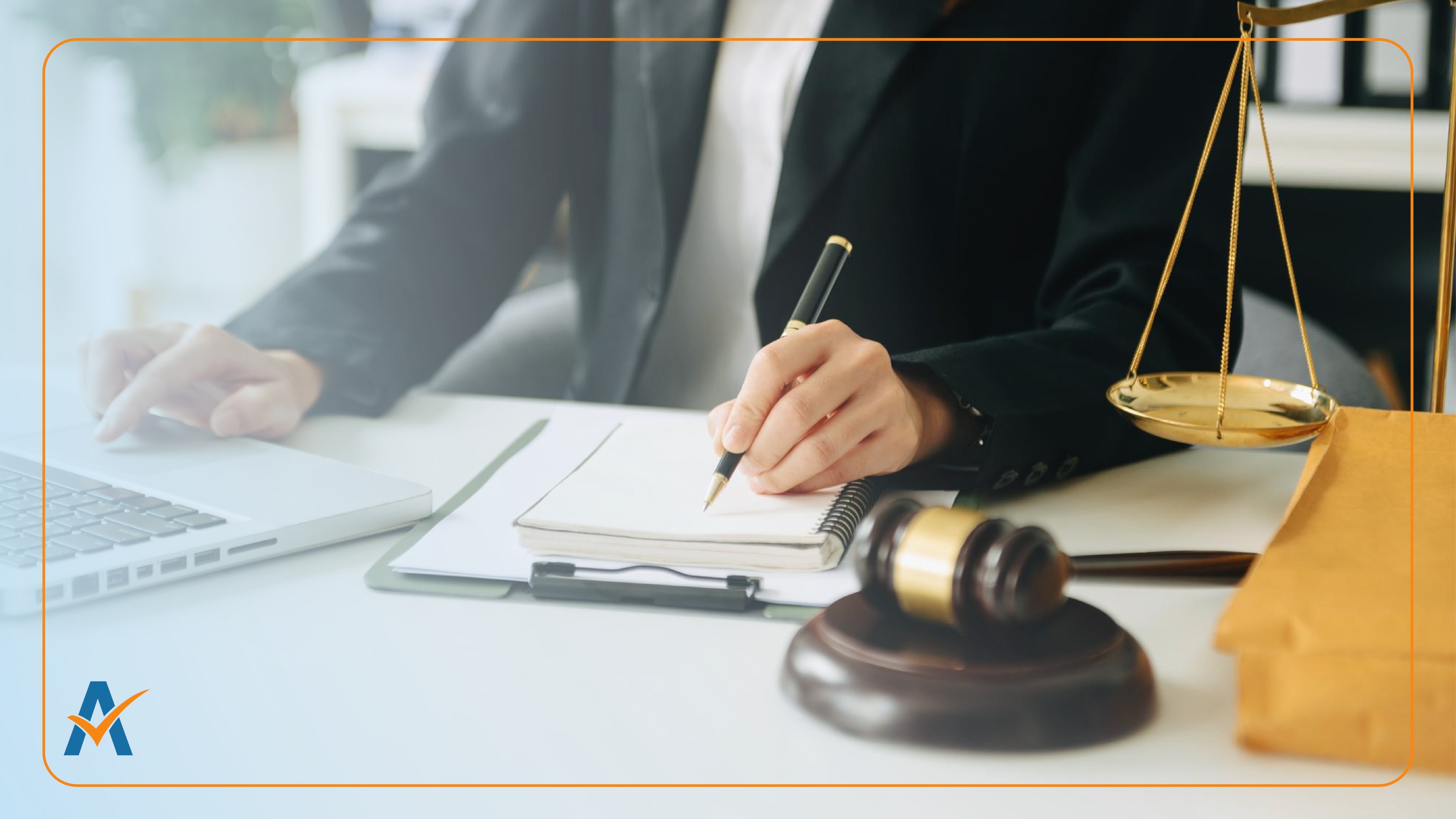 Person writing at desk with laptop, legal gavel, and scales representing Telephone Consumer Protection Act compliance.