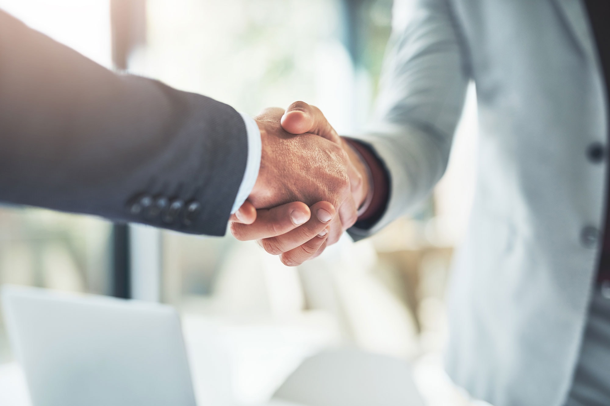 Close-up of a handshake symbolising agreement in a property trust transaction