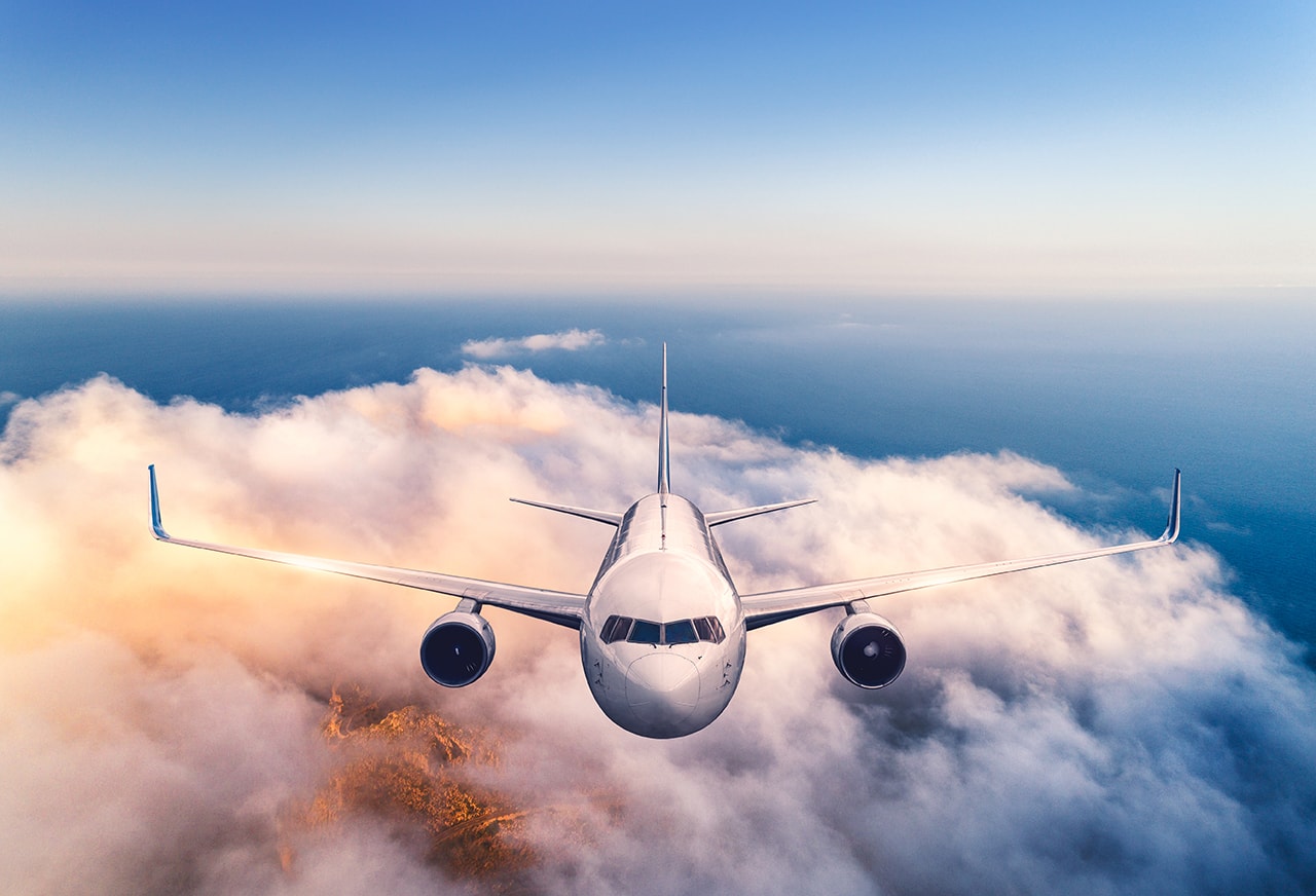 commercial aircraft flying at maximum altitude, showcasing the vast sky and clouds