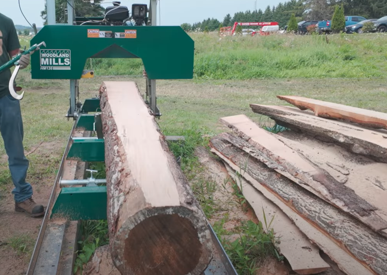 The first cut of a cant on a Woodland Mills HM126 Portable Bandsaw Mill.