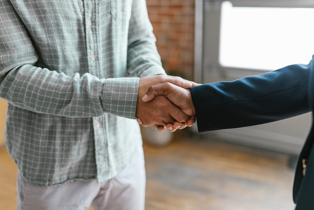 Investor handshake between executives.