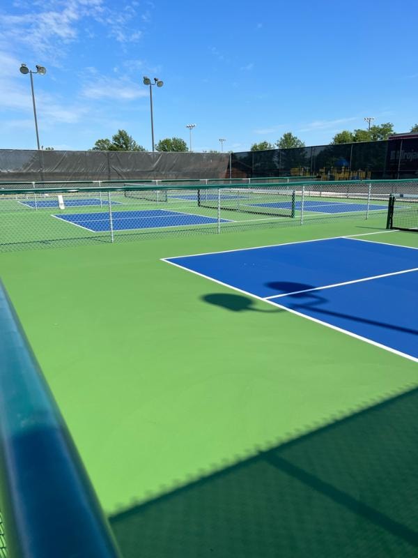 Resurfaced pickleball courts at Sheridan Park in Eldridge City, IA, featuring a smooth, freshly colored surface after crack repairs, rust removal, and resurfacing.