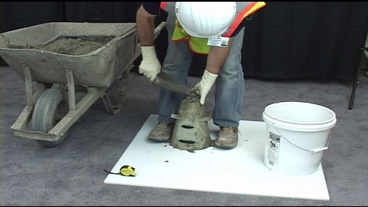 A person performing a hydraulic cement concrete test