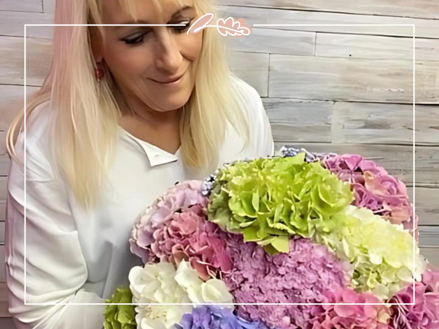 A florist at Fabulous Flowers and Gifts admiring a pastel-coloured bouquet of hydrangeas ready for same day delivery. Your Perfect Bouquet of Flowers.