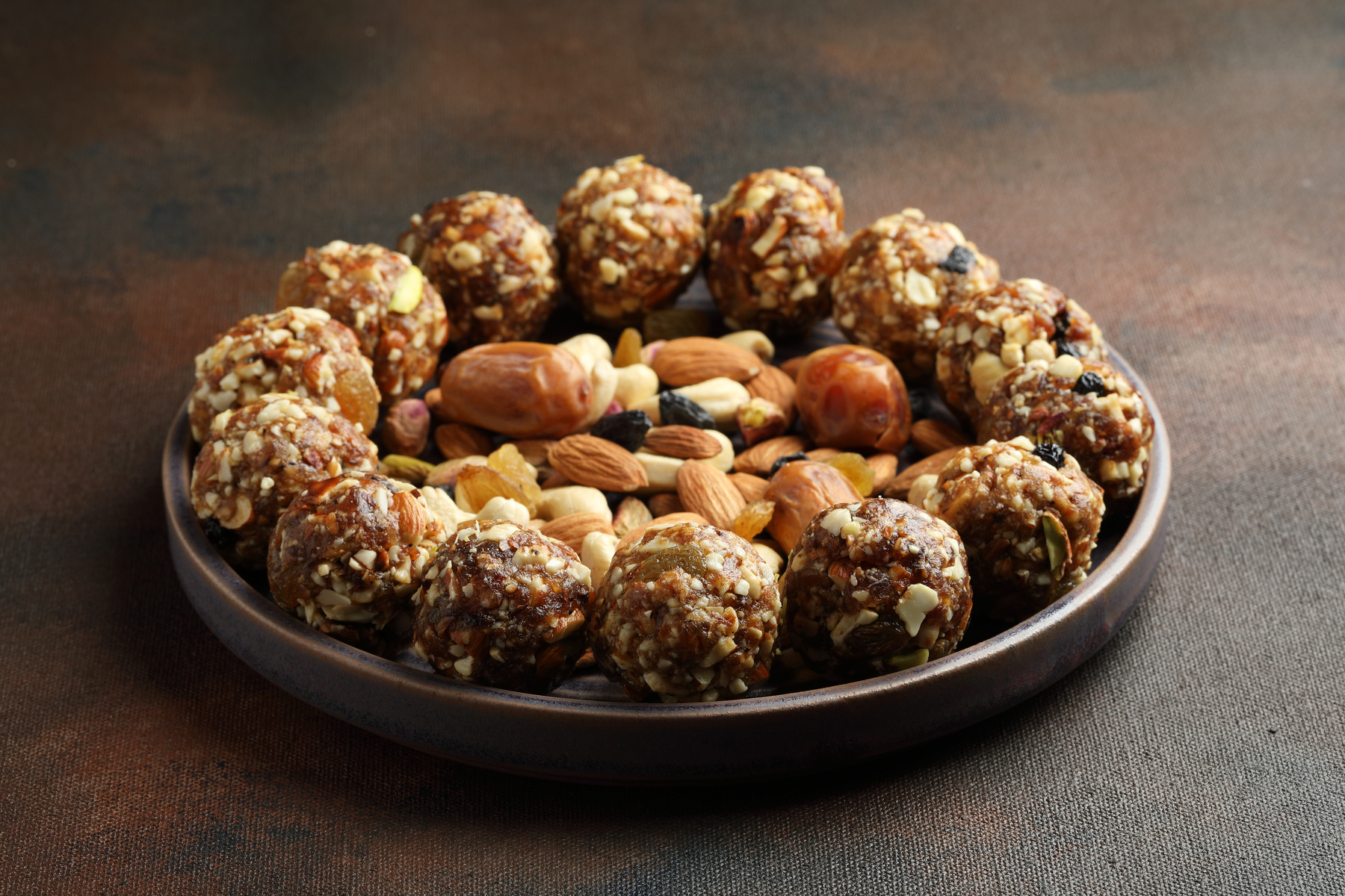 A variety of dry-fruit-based North Indian sweets arranged on a platter