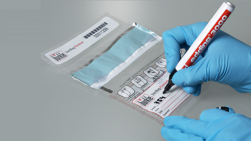 Healthcare worker labeling a tamper-evident bag